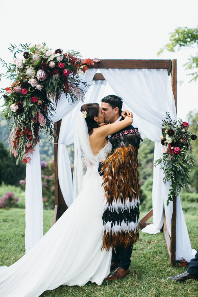 Rustic ceremony arbour design featuring king protea