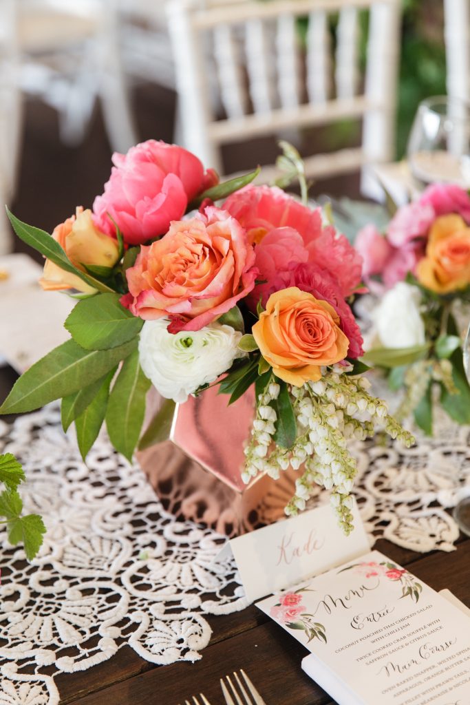 Copper geometric vase featuring coral peonies