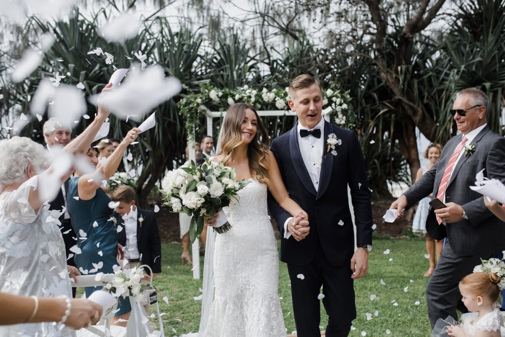 Modern white wedding bouquet featuring dahlias and lush greenery