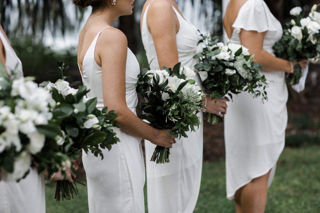 Modern white wedding bouquet featuring dahlias and lush greenery