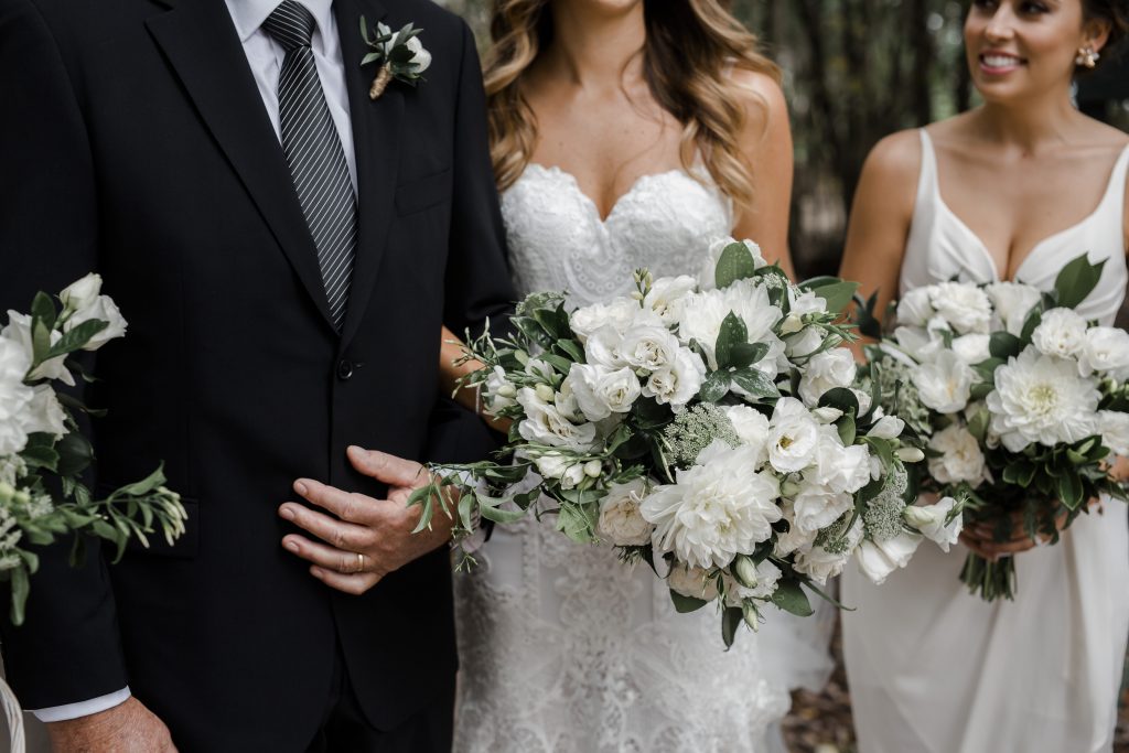 Modern white wedding bouquet featuring dahlias and lisianthus